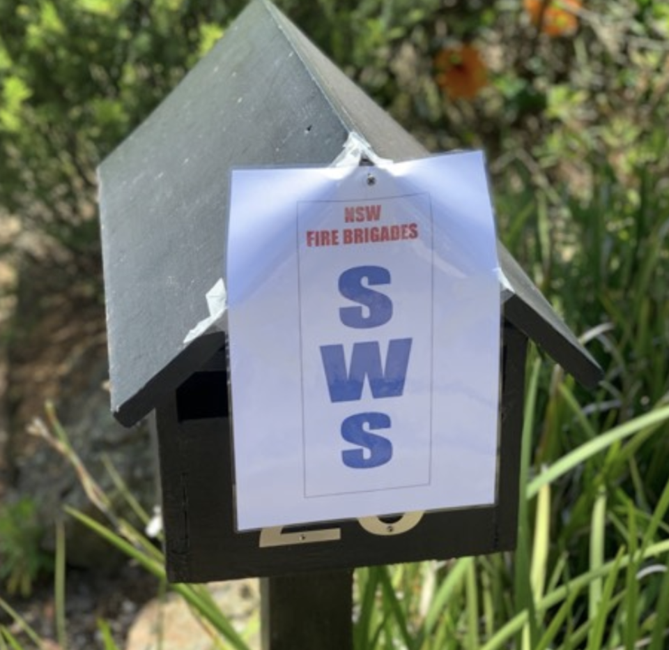 Pictured is a sign stuck to a letterbox with the letters SWS, which stands for static water supply. 