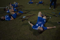 The soccer player of Israel Amputee Football Team, Ben Binyamin, right, stretches after a practice session in Ramat Gan, Thursday, April 11, 2024. The team offers players the excitement of competition, an outlet for their energies and the healing powers of sport, of overcoming the mental and physical challenges of disability. (AP Photo/Leo Correa)