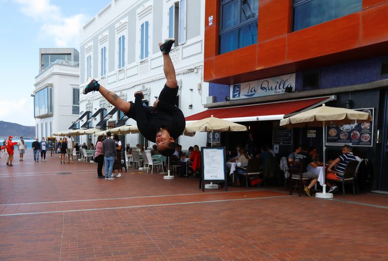 A street artist performs near tourists, in Gran Canaria