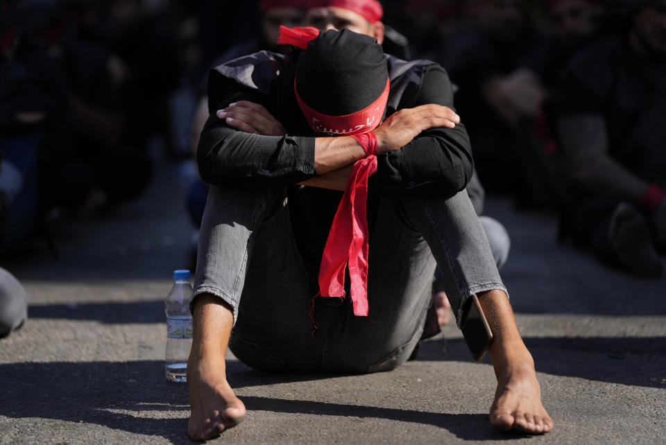 Shiite Lebanese members of Iranian-backed Hezbollah group, mourns as he listens to the death story of Imam Hussein during the holy day of Ashoura that commemorates the 7th century martyrdom of the Prophet Muhammad’s grandson Hussein, in the southern suburb of Beirut, Lebanon, Tuesday, Aug. 9, 2022. The leader of Lebanon’s militant Hezbollah group has issued warning to archenemy Israel over the two countries' maritime border dispute. (AP Photo/Hussein Malla)