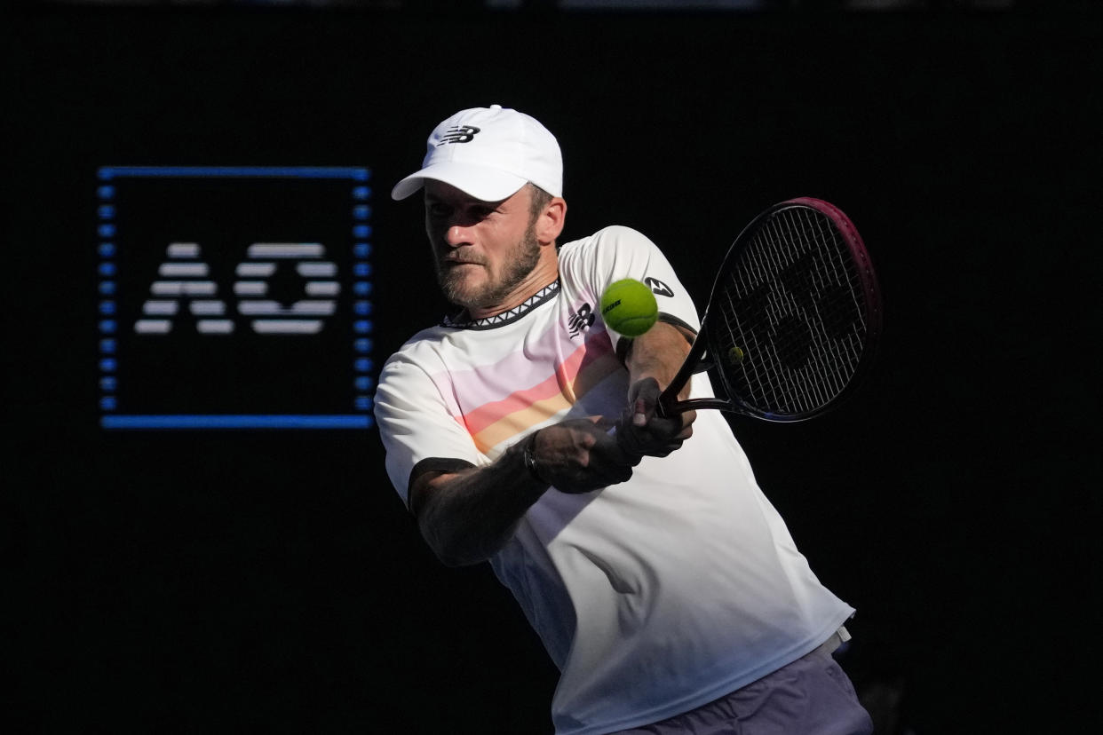 Tommy Paul of the U.S. plays a backhand return to compatriot Ben Shelton during their quarterfinal match at the Australian Open tennis championship in Melbourne, Australia, Wednesday, Jan. 25, 2023. (AP Photo/Dita Alangkara)