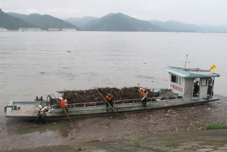 Dredgers work on collecting trash from the Yangtze river in Fengdu county in Chongqing