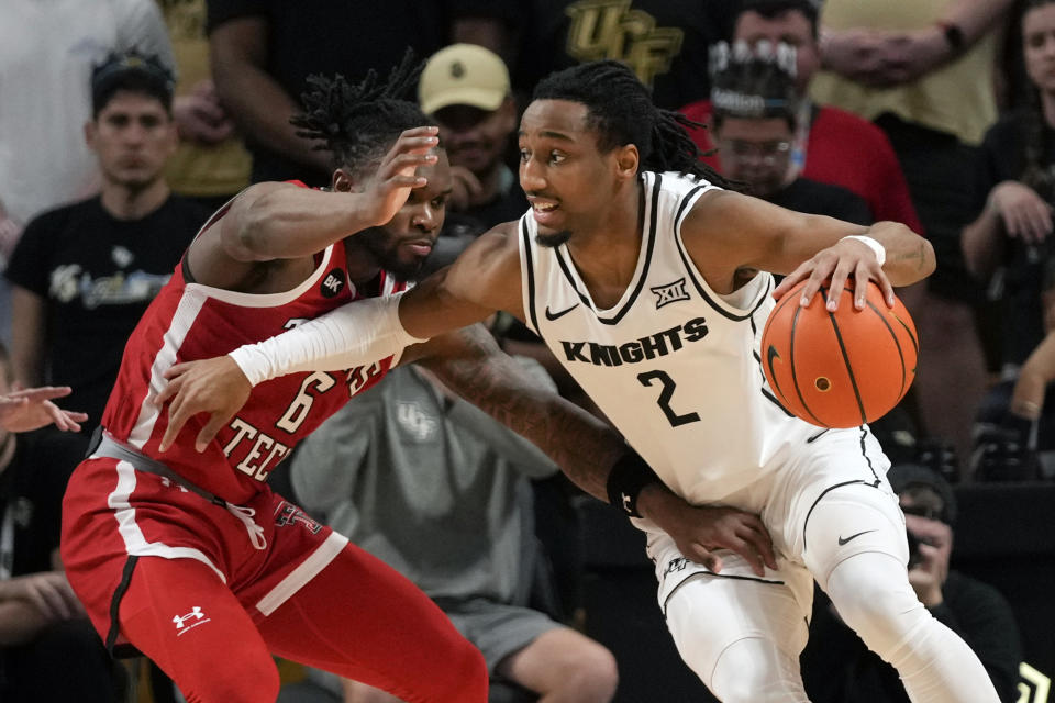 Central Florida guard Shemarri Allen (2) drives around Texas Tech guard Joe Toussaint (6) during the first half of an NCAA college basketball game, Saturday, Feb. 24, 2024, in Orlando, Fla. (AP Photo/John Raoux)