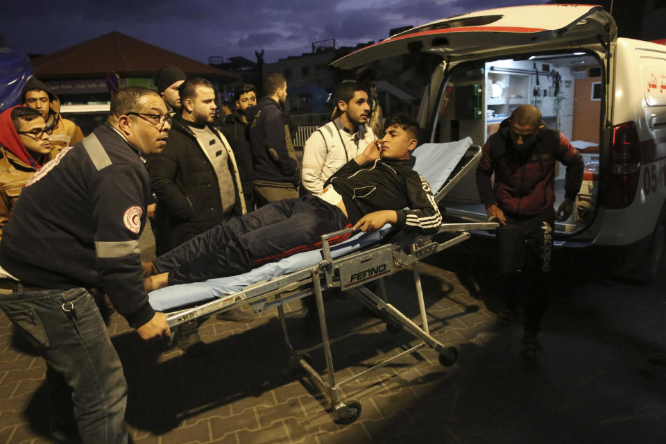 Palestinian medics move a wounded youth who was shot by Israeli troops during a protest at the Gaza Strip's border with Israel, at the Shifa hospital in Gaza City, Friday, Dec. 7, 2018. (AP Photo/Adel Hana)