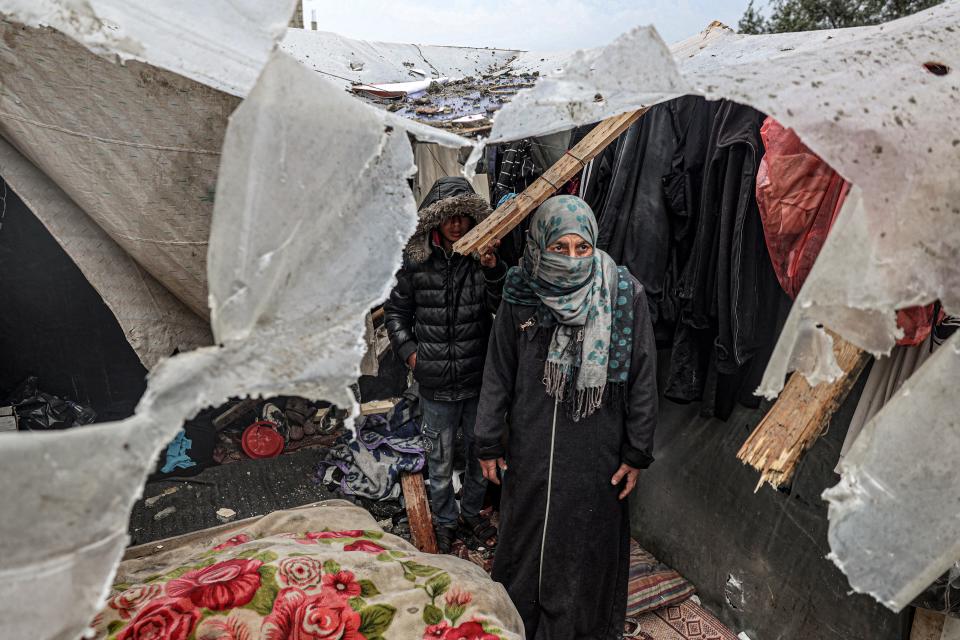 Displaced Palestinians inspect the damage to their tents following overnight Israeli bombardment at the Rafah refugee camp in the southern Gaza Strip on March 19, 2024.