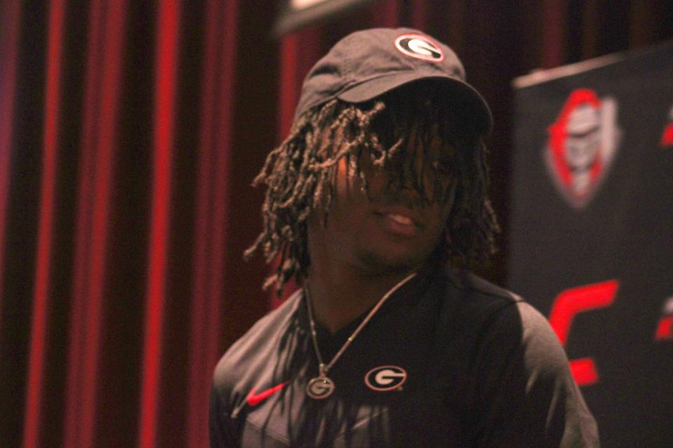 Creekside's Christian Miller stands up with a University of Georgia cap at his college signing on November 8, 2023. [Clayton Freeman/Florida Times-Union]