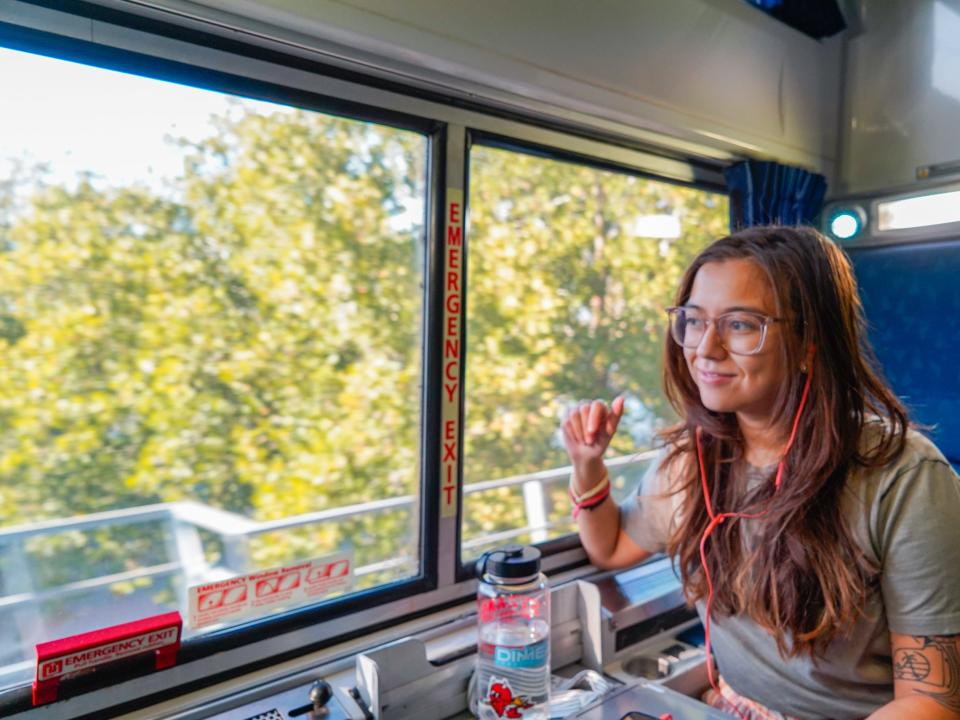 The author sitting in a train to Miami with greenery out the window