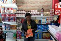 A woman check prices of a detergent in the "bodegon" named "Mini Walmart" in Puerto Cabello