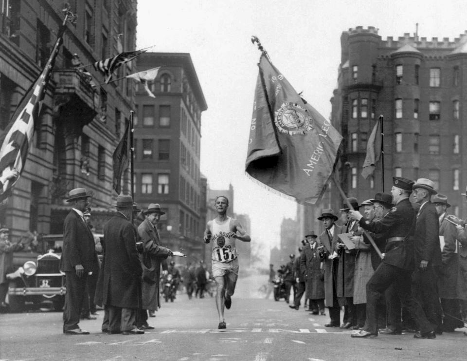 FILE - In this April 19, 1930 file photo, veteran marathoner Clarence DeMar, of the Melrose American Legion Post, crosses the finish line to win the Boston Marathon in the last of his record seven wins in Boston. A new film that captures much of the Boston Marathon's colorful history premieres Saturday, April 15, 2017, in conjunction with the 121st running of the race on Monday. (AP Photo, File)