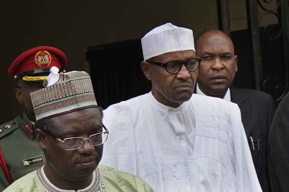 Incumbent President Muhammadu Buhari, center, leaves his party's headquarters after holding an emergency meeting with senior members of the All Progressives Congress (APC) in Abuja, Nigeria, Monday Feb. 18, 2019. Nigeria's electoral commission delayed the presidential election until Feb. 23. (AP Photo/Jerome Delay)