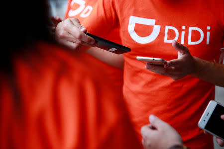 The logo of Chinese ride-hailing firm Didi Chuxing is seen on a t-shirt of an employee outside their new drivers center in Toluca, Mexico, April 23, 2018. REUTERS/Carlos Jasso