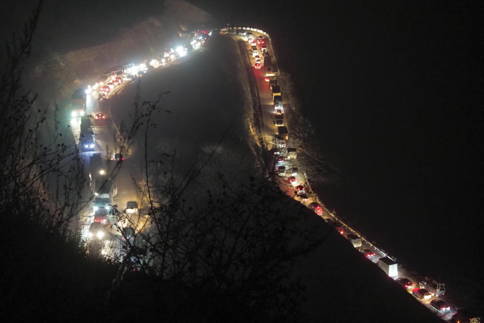 Cars and trucks stuck in a huge traffic jam climbing along the road from Kalbajar to a mountain pass leaving the separatist region of Nagorno-Karabakh to Armenia, on Saturday, Nov. 14, 2020. The territory is to be turned over to Azerbaijan on Sunday as part of territorial concessions in an agreement to end six weeks of intense fighting with Armenian forces. Hundreds of thousands of Azeris were displaced by the war that ended in 1994. It is unclear when any civilians might try to settle in Karvachar — which will now be known by its Azeri name Kalbajar — or elsewhere. (AP Photo/Dmitry Lovetsky)