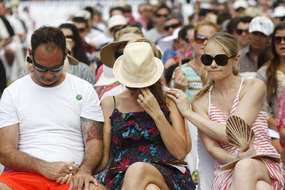 Australian relatives of the victims of the 2002 Bali bombings comfort each other during a memorial service, marking the 10th anniversary of the terrorist attacks at nightclubs in Kuta that killed 202 people, including 88 Australians and seven Americans, in Jimbaran in Bali, Indonesia, Friday, Oct. 12, 2012. (AP Photo/Made Nagi, Pool)