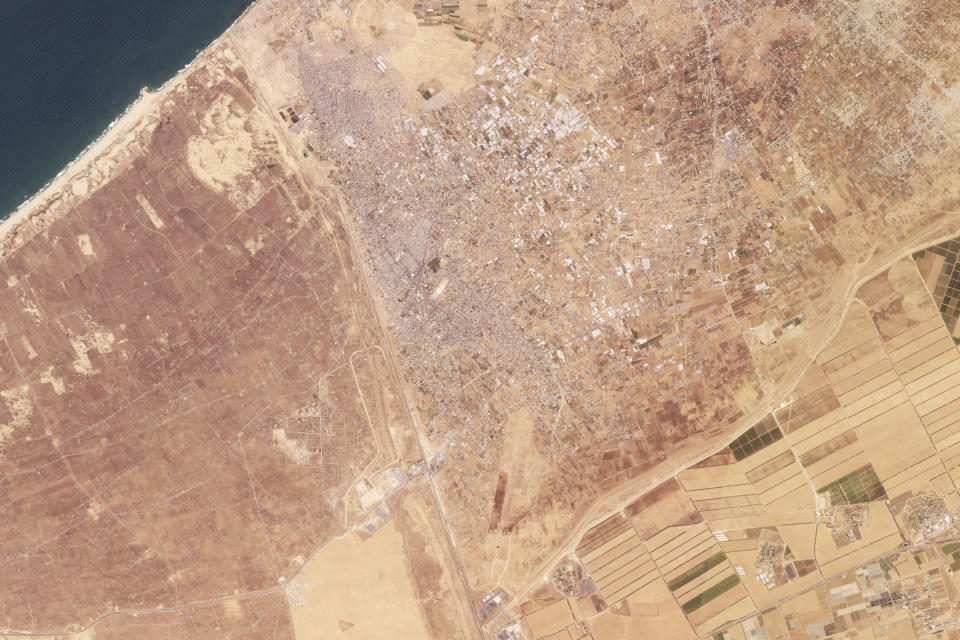 This satellite image taken by Planet Labs PBC shows Rafah in the Gaza Strip, center, Saturday, May 4, 2024. The Israeli army ordered some 100,000 Palestinians on Monday, May 6, 2024, to begin evacuating from the southern city of Rafah in Gaza, signaling that a long-promised ground invasion there could be imminent and further complicating efforts to broker a cease-fire. In the image, Egypt can be seen to the left, Israel to the bottom right corner. (Planet Labs PBC via AP)