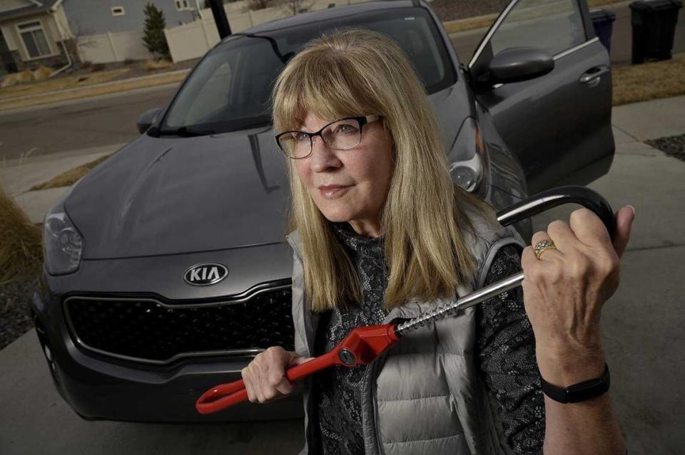 Debbie McClung holds a Club Steering Wheel Lock for her 2017 Kia Sportage at her home in Denver on March 14. McClung said her car had been stolen twice. Hyoung Chang/Denver Post