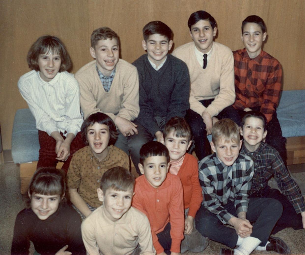 John Walsh, seated on floor fifth from left, and his older brother and cousins at a family gathering circa 1965.