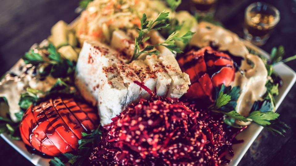 Vegetable Salad With Cheese And Glasses Of Rakia On Wooden Table.