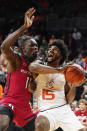 Miami's forward Norchad Omier (15) drives to the basket as Rutgers' center Clifford Omoruyi (11) defends during the first half of an NCAA college basketball game, Wednesday, Nov. 30, 2022, in Coral Gables, Fla. (AP Photo/Marta Lavandier)