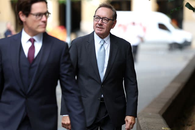 <p>HENRY NICHOLLS/AFP via Getty</p> Spacey arrived at court wearing a black suit and patterned sky blue tie