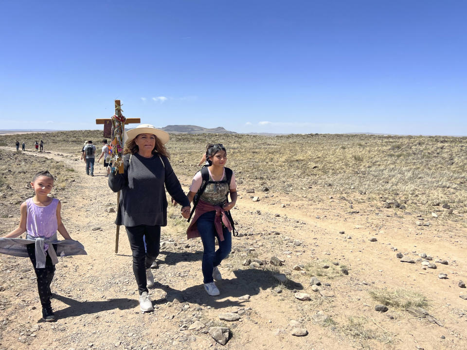 Catholic pilgrims journey to Tome Hill, in Los Lunas, N.M., as part of an annual Good Friday pilgrimage, April 7, 2023. (AP Photo/Felicia Fonseca)