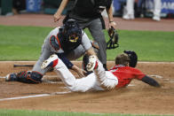 Cleveland Indians' Jordan Luplow, right, scores past Detroit Tigers' Austin Romine on a double by Domingo Santana during the sixth inning of a baseball game, Saturday, Aug. 22, 2020, in Cleveland. (AP Photo/Ron Schwane)