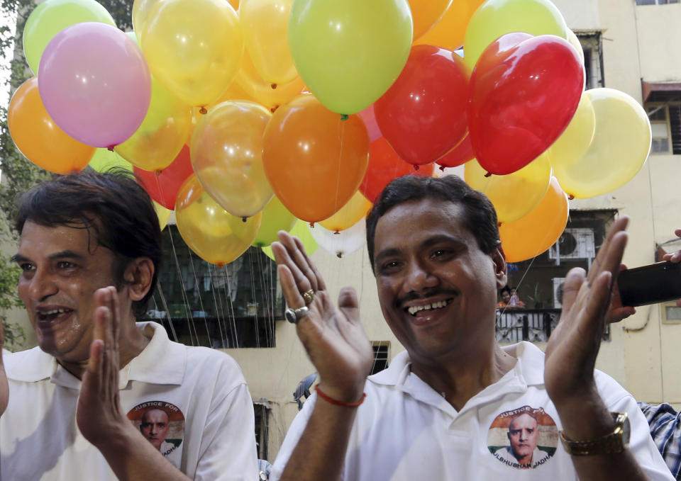 Indian friends of Kulbhushan Jadhav, celebrate verdict of International Court of Justice in Mumbai, India, Wednesday, July 17, 2019. The United Nations' highest court has ordered that Pakistan stay the execution of Jadhav, an alleged Indian spy and ordered that his case be reviewed after agreeing with India's contention that his rights had been violated. (AP Photo/Rajanish Kakade)