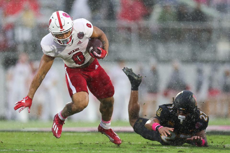 Cure Bowl: Miami Redhawks running back Rashad Amos (0) breaks a tackle by Appalachian State safety Ronald Clarke (27).