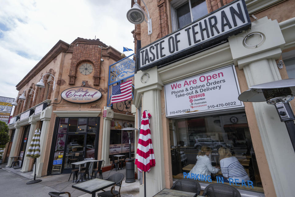 The Pink Orchid bakery and cafe" and the Taste of Tehran restaurant are seen in the so-called "Tehrangeles" neighborhood in the Westwood district of Los Angeles on Monday, May 20, 2024. (AP Photo/Damian Dovarganes)