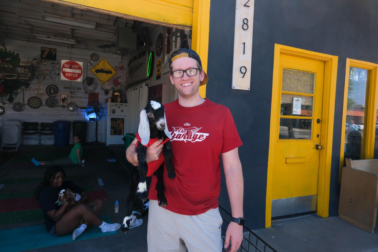 Jesse Melson stands with one of his yoga goats last weekend at The Garage event venue on the Historic Route 66 in Amarillo.