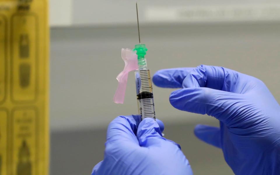 senior Clinical Research Nurse Ajithkumar Sukumaran prepares the COVID-19 vaccine to administer to a volunteer, at a clinic in London. - AP