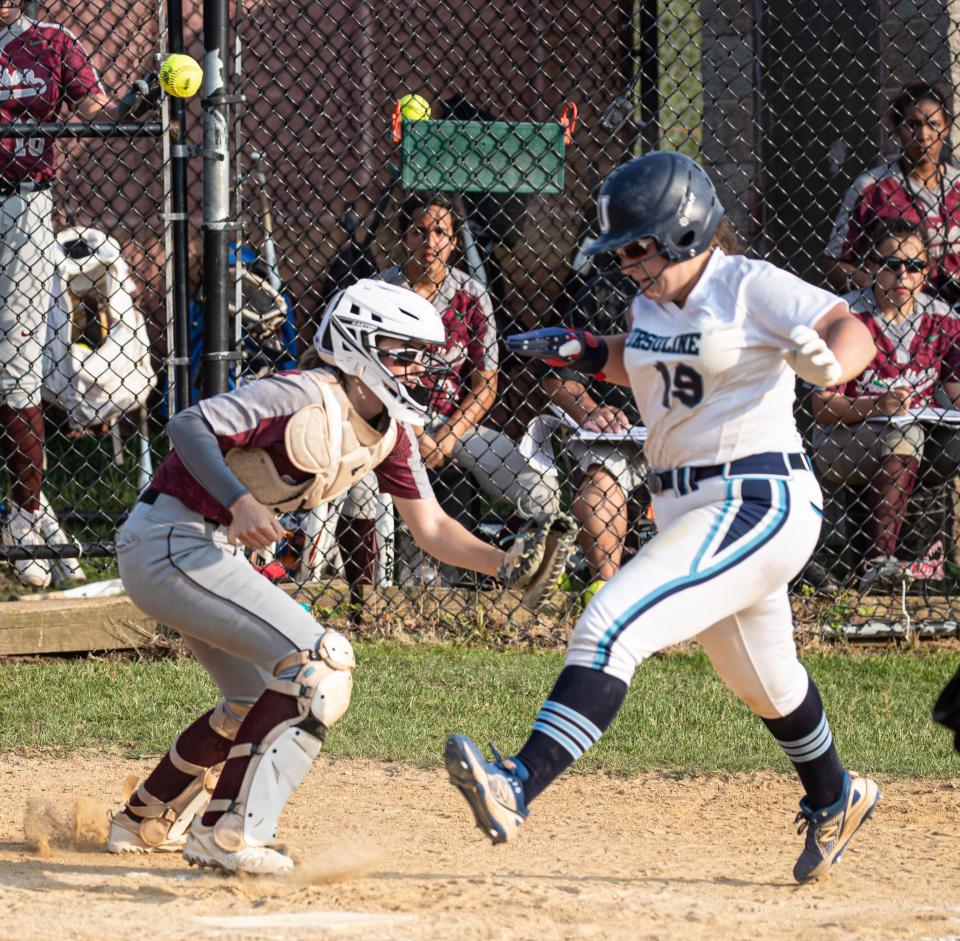 Ursuline’s Emilia Mancusi scores as Harrison catcher Barbara Jo Coppola doesn’t handle the throw in the sixth inning of a Section 1 Class A softball semifinal game at Harrison High School May 23, 2023. Ursuline scored three runs in the sixth inning to defeat Harrison 8-5. 