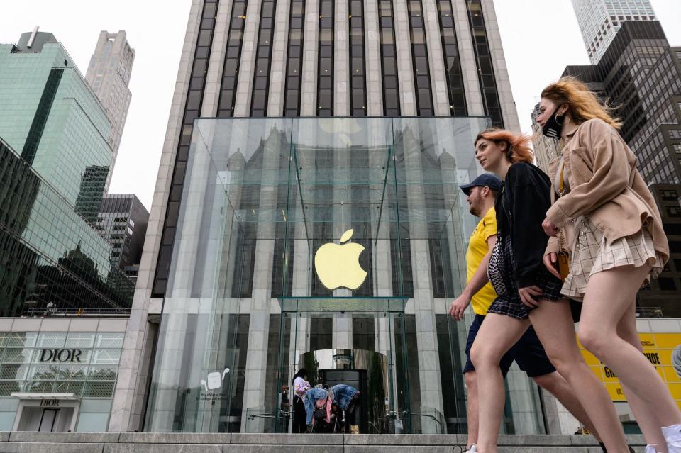 People walk past an Apple retail store on July 13, 2021 in New York City. - Stock markets were slightly softer on news of the biggest jump in US inflation in more than two decades and disappointment in results from US investment banks. As trading ended in London, Frankfurt and Paris, major indices hovered around the zero mark, while the Dow Jones index was also a tiny bit lower in midday New York exchanges. (Photo by Angela Weiss / AFP) (Photo by ANGELA WEISS/AFP via Getty Images)