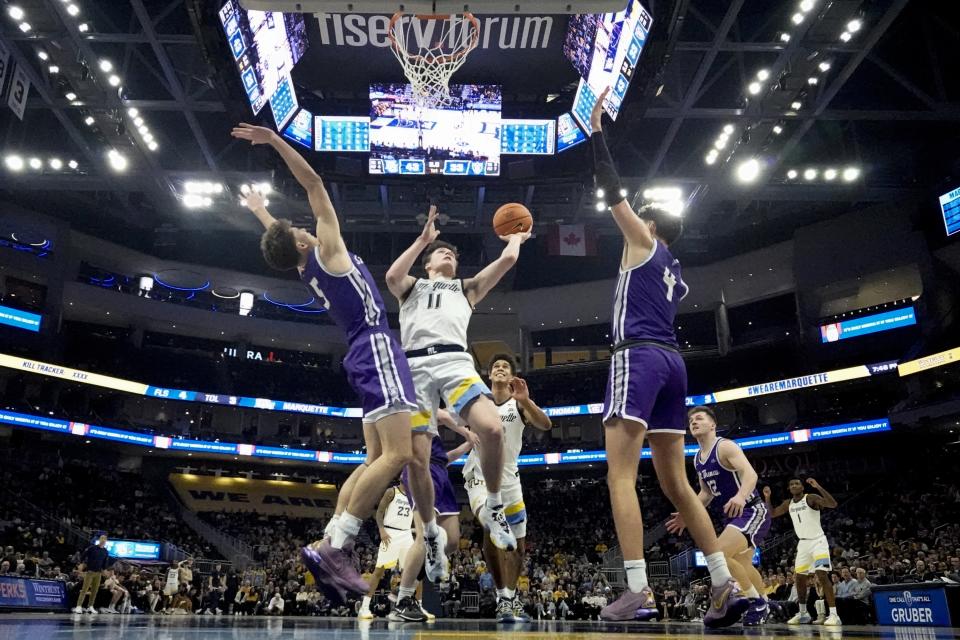 Marquette's Tyler Kolek shoots between St. Thomas's Brooks Allen and Parker Bjorklund during the first half of an NCAA college basketball game Thursday, Dec. 14, 2023, in Milwaukee. (AP Photo/Morry Gash)