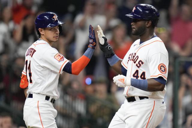 Houston Astros' Yordan Alvarez (44) celebrates with Mauricio Dubon after scoring against the Cleveland Guardians during the sixth inning of a baseball game Wednesday, May 25, 2022, in Houston. (AP Photo/Eric Christian Smith)