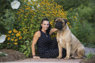In this undated photo provided by Cassandra Carpenter, handler Cassandra Carpenter poses with Titus, a bullmastiff. Cassandra says Titus was bitten by a snake on his back left leg in March 2019 in North Carolina. Titus went through extensive treatment and recovery and still has a scar from the episode. He is entered in the Westminster Kennel Club dog show in New York. (Amber Jade via AP)