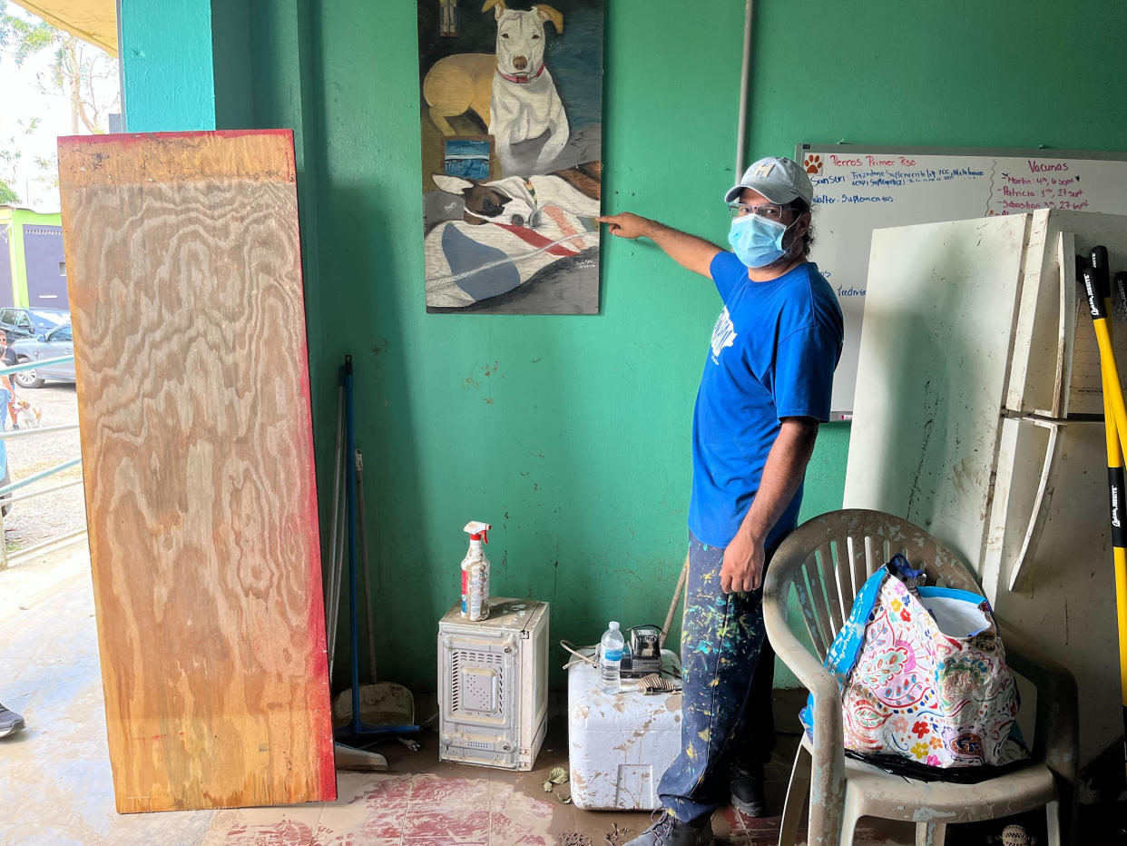 Angel Vega, who does maintenance for the sanctuary and who has worked at the shelter for 7 years, points out how high the flood waters reached inside the first floor. (Danielle Campoamor / TODAY)