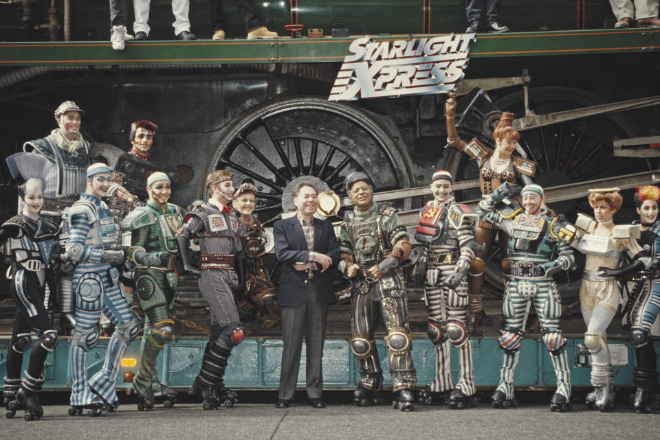 English composer Andrew Lloyd Webber pictured in centre with the cast of his West End stage musical 'Starlight Express', circa 1984. (Photo by Larry Ellis Collection/Getty Images)