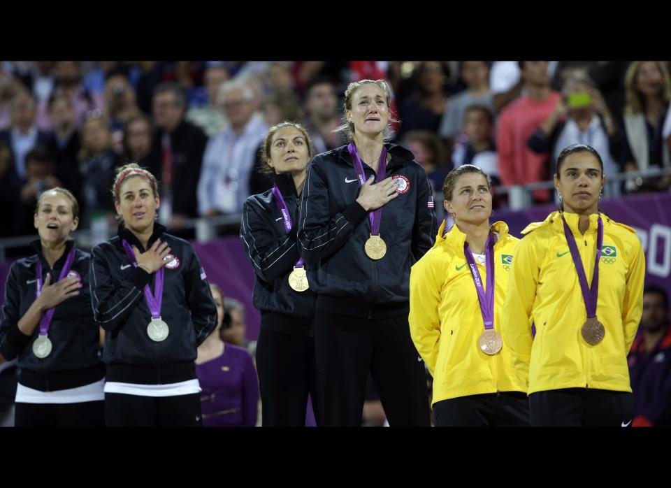 Women's beach volleyball medalists listen to the USA national anthem following the Gold Medal match between two United States teams during at the 2012 Summer Olympics, Wednesday, Aug. 8, 2012, in London. 