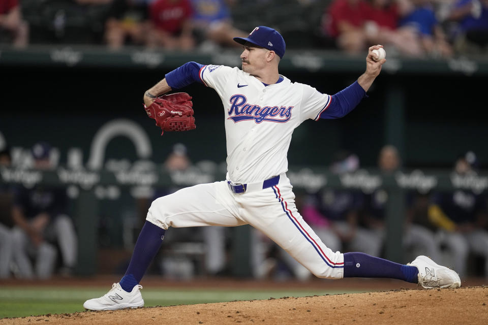 Texas Rangers starting pitcher Andrew Heaney throws to the Tampa Bay Rays in the third inning of a baseball game in Arlington, Texas, Saturday, July 6, 2024. (AP Photo/Tony Gutierrez)