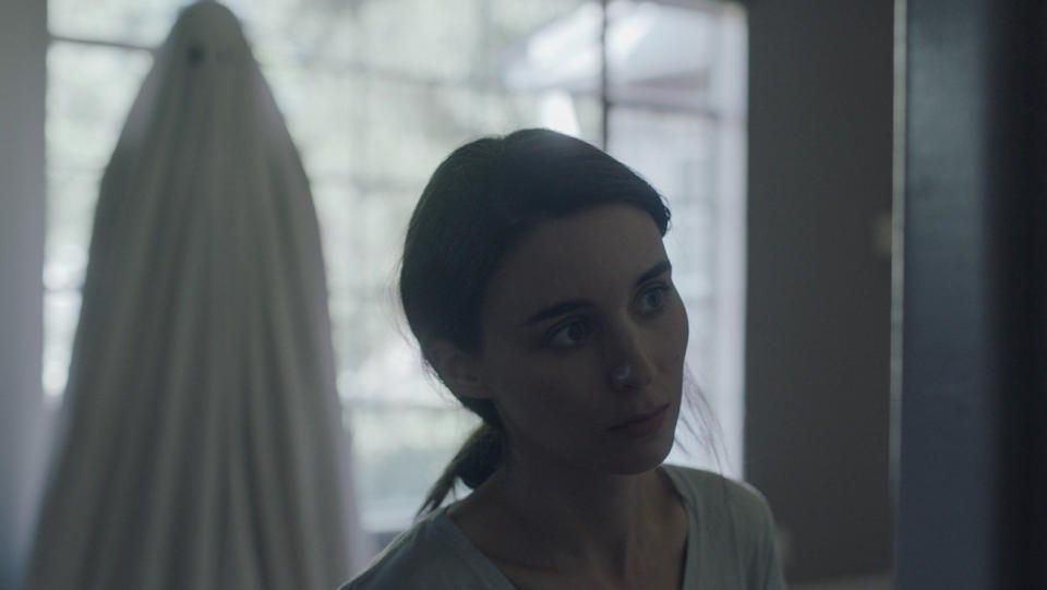 "A Ghost Story" may invite comparisons to Terrence Malick, Virginia Woolf, "Boyhood" and "Ugetsu," but it's a singular&nbsp;feat that needs no antecedents.&nbsp;Often wordless and always elliptical, David Lowery's feature-length ballad interrogates grief, the passage of time and the roles we play in the lives of our closest companions. The central couple's&nbsp;quotidian conflicts are put to rest when one member (Casey Affleck) dies in a car crash, returning as a bedsheet-clad&nbsp;specter traipsing around the home&nbsp;he once shared with his wife&nbsp;(Rooney Mara). From there, the movie weaves through time, gently probing what happens to&nbsp;a soul once&nbsp;the body it inhabited perishes. It doesn't purport to answer life's big questions, instead finding peace in the search for meaning. Can you sense from this writing that it's a hard concept to describe? You're right, and the film is all the better for it. Rarely is the afterlife&nbsp;explored with such&nbsp;divine, peerless grace.