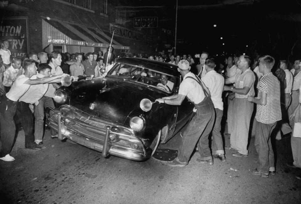 A crowd attacks cars driven by African Americans to protest integration in the schools, as seen in the new PBS documentary "Driving While Black."