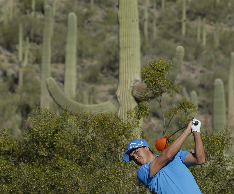 Rickie Fowler watches his tee shot on the 17th hole during a practice round at the Match Play Championship golf tournament on Tuesday, Feb. 18, 2014 in Marana, Ariz. (AP Photo/Chris Carlson)