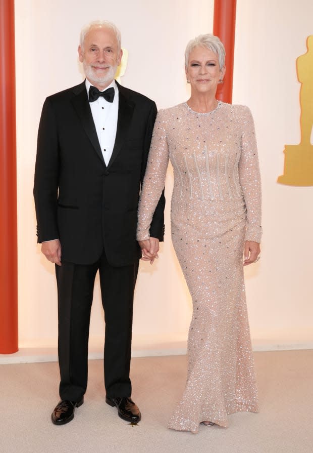 HOLLYWOOD, CALIFORNIA - MARCH 12: (L-R) Christopher Guest and Jamie Lee Curtis attend the 95th Annual Academy Awards on March 12, 2023 in Hollywood, California. (Photo by Kevin Mazur/Getty Images)<p><a href="https://www.gettyimages.com/detail/1473054144" rel="nofollow noopener" target="_blank" data-ylk="slk:Kevin Mazur/Getty Images;elm:context_link;itc:0;sec:content-canvas" class="link ">Kevin Mazur/Getty Images</a></p>
