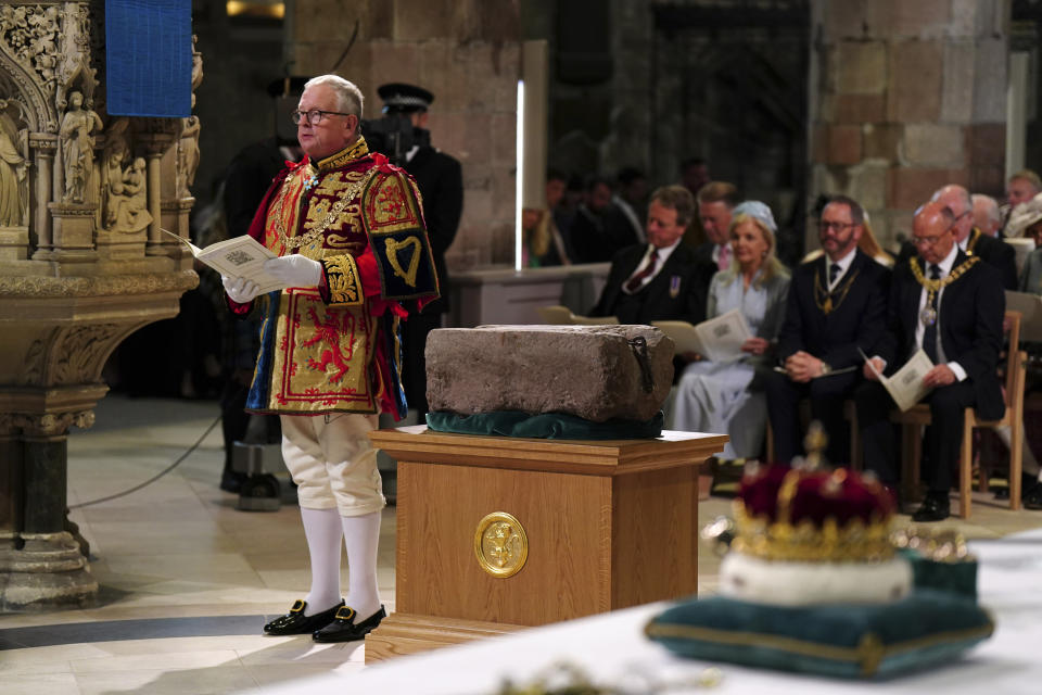 FILE - Lord Lyon King of Arms Joseph Morrow and the Stone of Destiny, also known as the Stone of Scone, during an event at St Giles' Cathedral, July 5, 2023, in Edinburgh. Some of the words tied to this year's hottest topics were also among the most mangled when it came to saying them aloud including the name of the sacred slab of sandstone used in the coronation of King Charles III. This year's lists of the most mispronounced words in the U.S. and Britain were released on Thursday, Dec. 7. (Jane Barlow/Pool photo via AP, File)