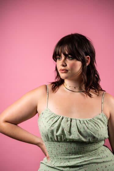 Barbie Ferreira of "Euphoria" posing with hand to hip, bangs in a green flowered dress