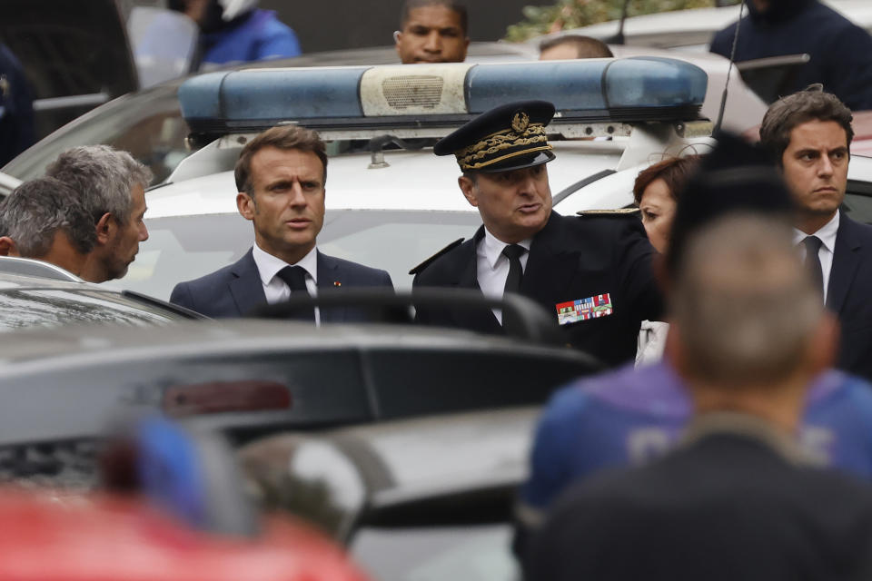 French President Emmanuel Macron arrives at the Gambetta high school in Arras, northeastern France, Friday Oct. 13, 2023. A man of Chechen origin who was under surveillance by the French security services stabbed a teacher to death at his former high school and critically wounded two other people in northern France on Friday, authorities said. (Ludovic Marin, Pool via AP)