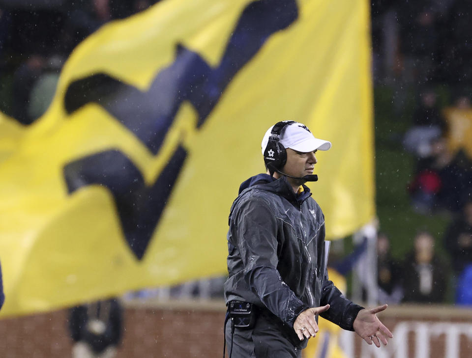 West Virginia head coach Neal Brown waits to greet his players after they scored against Baylor in the first half of an NCAA college football game, Saturday, Nov. 25, 2023, in Waco, Texas. (Jerry Larson/Waco Tribune-Herald, via AP)