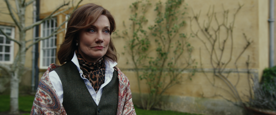 Joley Richardson as Lady Sabrina in 'The Gentlemen' stands outside her family's estate with a very set expression on her face. 