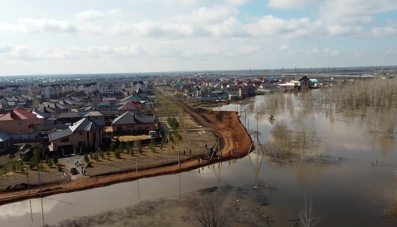 Russian villagers build homemade dam to keep out floods, in Orenburg region