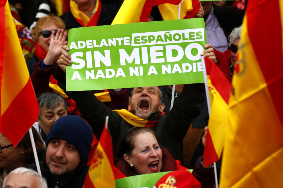 Demonstrators hold banners and Spanish flags during a protest in Madrid, Spain, on Sunday, Feb.10, 2019. Thousands of Spaniards in Madrid are joining a rally called by right-wing political parties to demand that Socialist Prime Minister Pedro Sanchez step down. Banner reads in Spanish "Go ahead Spaniards, no fear to anything nor nobody". (AP Photo/Andrea Comas)